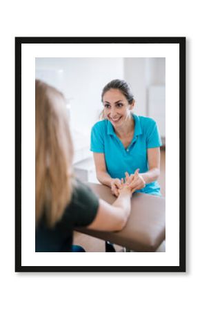 Female physiotherapist giving patient a hand massage