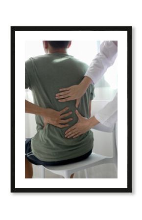 Asian male patient receives physical therapy with a physical therapist specializing in pain management in a hospital