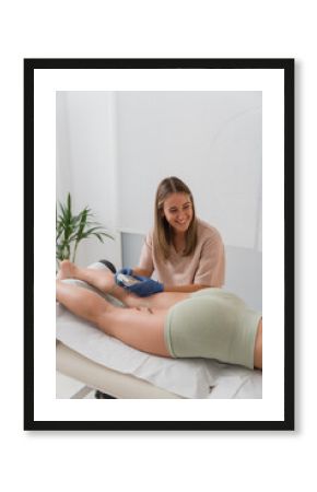Physiotherapist applying electro acupuncture dry needling treatment on patient leg