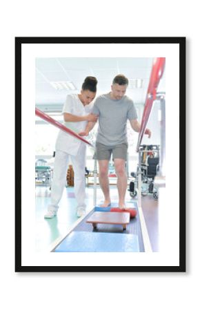 man assisted by nurse in rehab clinic