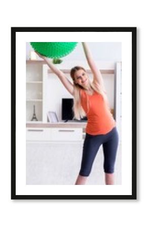 Young woman preparing for birth exercising at home