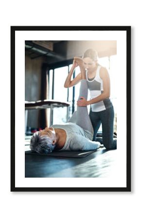 Stretching her way to strong. Shot of a senior woman working out with her physiotherapist.