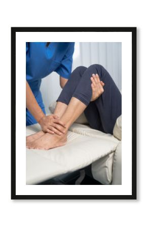 Female asian physiotherapist worker giving leg massage to senior woman, closeup. Rehabilitation physiotherapy in rehabilitation center, muscle weakness, Calf and knee pain