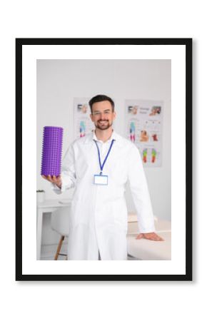 Male physiotherapist with foam roller in rehabilitation center