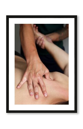 Masseur does back massage in spa center. Massage of myofascial trigger points on hands of male client to release tension. Rehabilitation, sport therapy medicine.