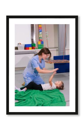 Child girl give five physiotherapist during sensory integration session. The concept of happiness and one team together. Cheerful kid and therapist celebrating teamwork at lesson.