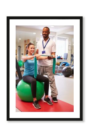 Female Patient Working With Physiotherapist In Hospital