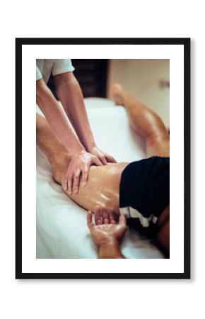 Sports massage. Therapist massaging leg