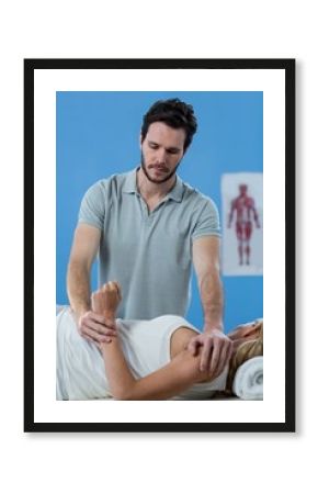 Male physiotherapist giving arm massage to female patient