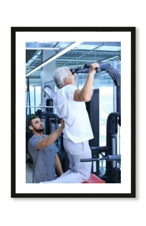 Rehabilitation concept. Mature man doing exercises under physiotherapist supervision