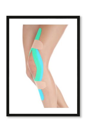 Female knee with physio tape on white background