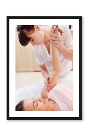 the massage therapist hands massage to a young beautiful pregnant girl