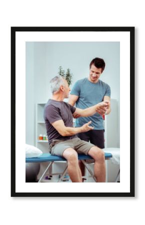 Nice senior man speaking with his nurse