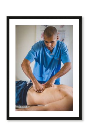 Macro close up of hands massaging female abdomen.Therapist applying pressure on belly.