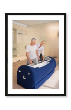 Grey-haired male patient getting ready for procedures in rehabilitation center