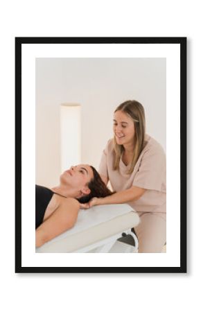 Physiotherapist performing neck manipulation on patient in clinic