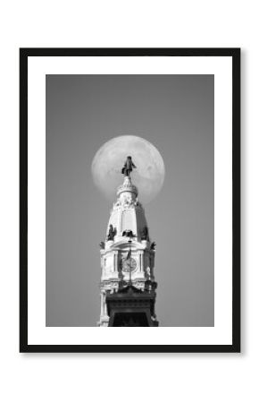 White full moon behind William Penn statue on Philadelphia City Hall in Philadelphia, Pennsylvania