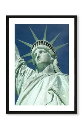 Statue of Liberty close-up vertical profile with crown against blue sky