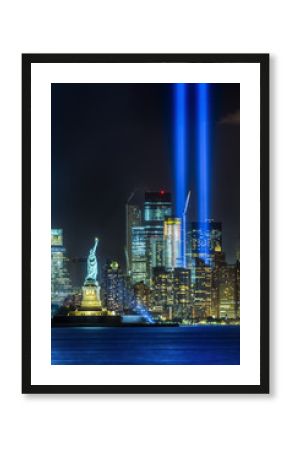 NEW YORK CITY - SEPTEMBER 11: The Statue of Liberty as seen in the evening of September 11, 2015 in New York City.  The 9-11 memorial lights can be seen in the background.