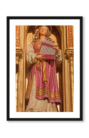 BRATISLAVA, SLOVAKIA - JANUARY 14, 2014: Holy Cecilia. Carved statue from 19. cent. by Ferdinand Prinoth from St. Ulrich on gothic side altar in st. Martin cathedral.