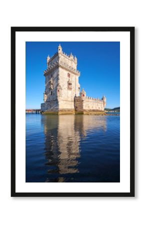 Belem Tower on river Tagus in Lisbon with reflection in water on blue sky background, Portugal