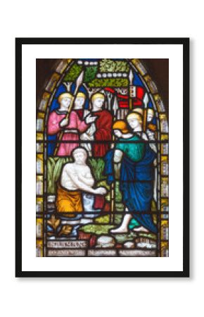 LONDON, GREAT BRITAIN - SEPTEMBER 19, 2017: The Naaman of Syria bathing in Jordan on the stained glass in St Mary Abbot's church on Kensington High Street.