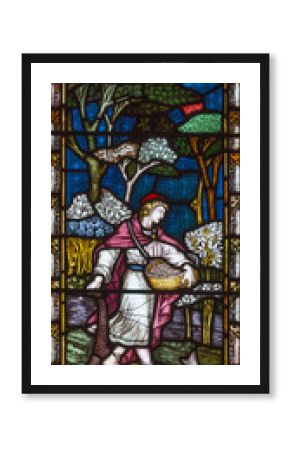 LONDON, GREAT BRITAIN - SEPTEMBER 19, 2017: The Parable of the Sower on the stained glass in St Mary Abbot's church on Kensington High Street.