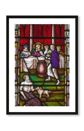 LONDON, GREAT BRITAIN - SEPTEMBER 19, 2017: The Parable of Rich man and Lazarus on the stained glass in St Mary Abbot's church on Kensington High Street.
