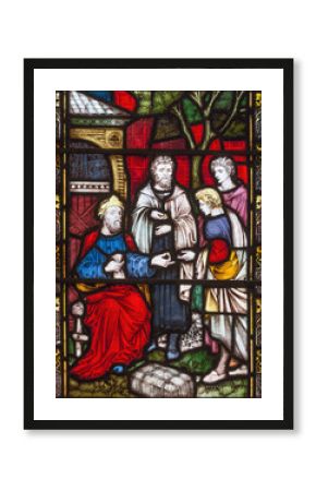 LONDON, GREAT BRITAIN - SEPTEMBER 19, 2017: The Parable of Talents on the stained glass in St Mary Abbot's church on Kensington High Street.