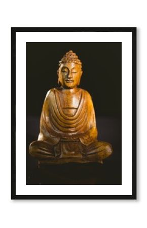Buddha statue over black background