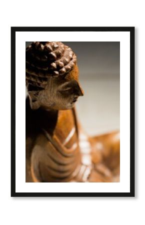 High angle view of wooden Buddha statue on floor