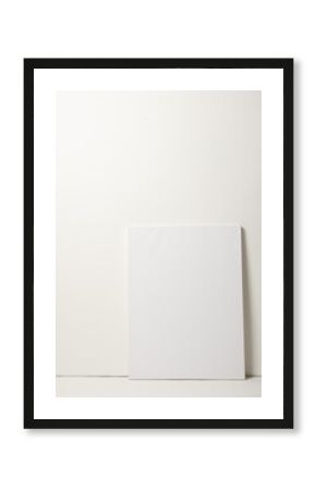 White canvas and copy space leaning against white wall background