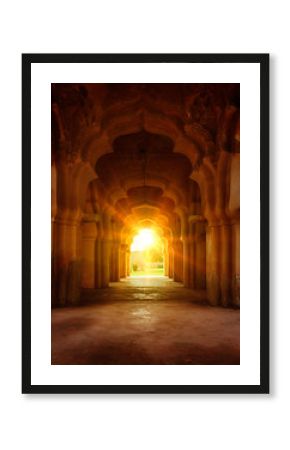 Old ruined arch in ancient palace at sunset