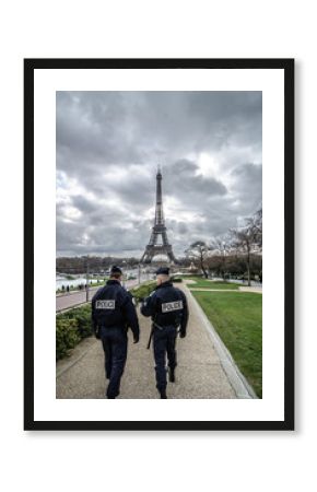 Paris , Paris Security agents guard the Eiffel Tower / Paris, France - March 18, 2012: Patrols of two police officers in the Trocadero gardens and Eiffel Tower.