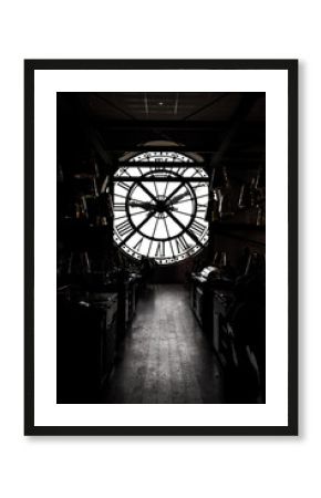 inside orsay museum and there is a big clock two people stand beside the clock