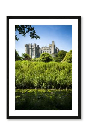 Arundel castle in lush green surroundings on sunny day  