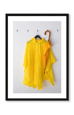 Raincoat and umbrella hanging on hook