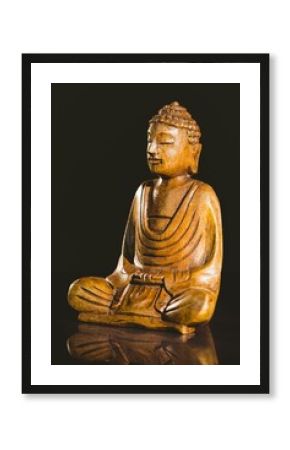 Buddha statue on table against black background