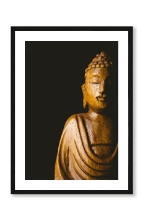 Buddha statue against black background
