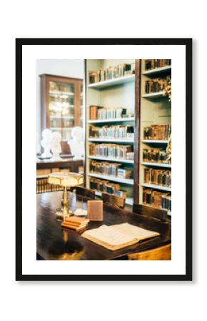 interior of an old house cabinet with books, wooden furniture and lamp