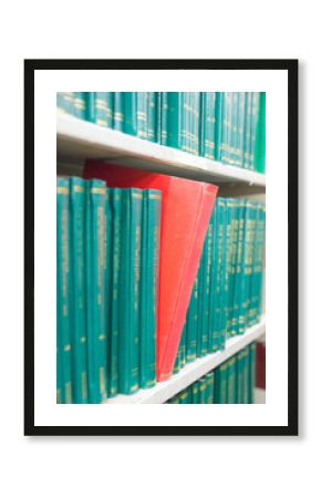 Book in a bookshelf standing out at university library
