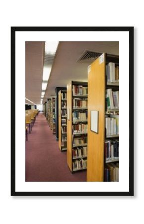 Volumes of books on bookshelf in library