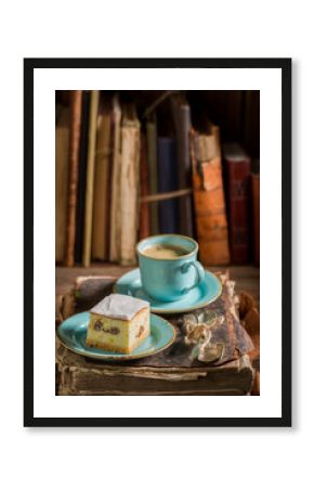 Sweet cheesecake and coffee on book in library