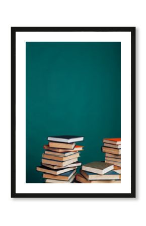 many stacks of educational books to teach in the school library on a green background