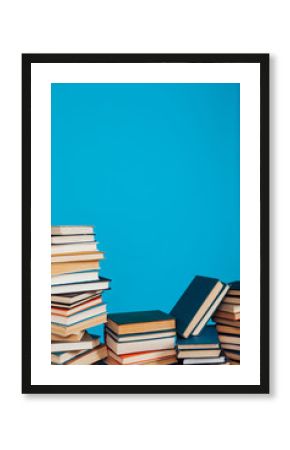 many stacks of educational books for exams at school in the library on a white background