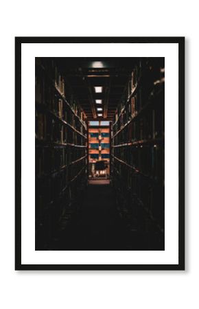 empty chair in the library framed by bookshelves
