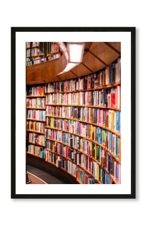 Colorful Books Lined Up on Curved Wooden Shelves in a Modern Library Providing a Vibrant and Inviting Atmosphere for Reading and Learning