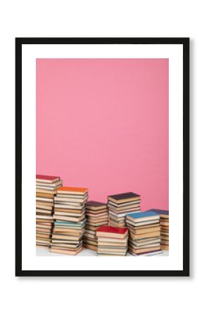 stack of books on a pink background in the learning library