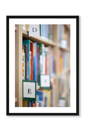 Book shelves with books and catalogue letter in library