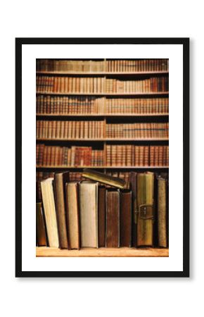 old books on wooden shelf in library.